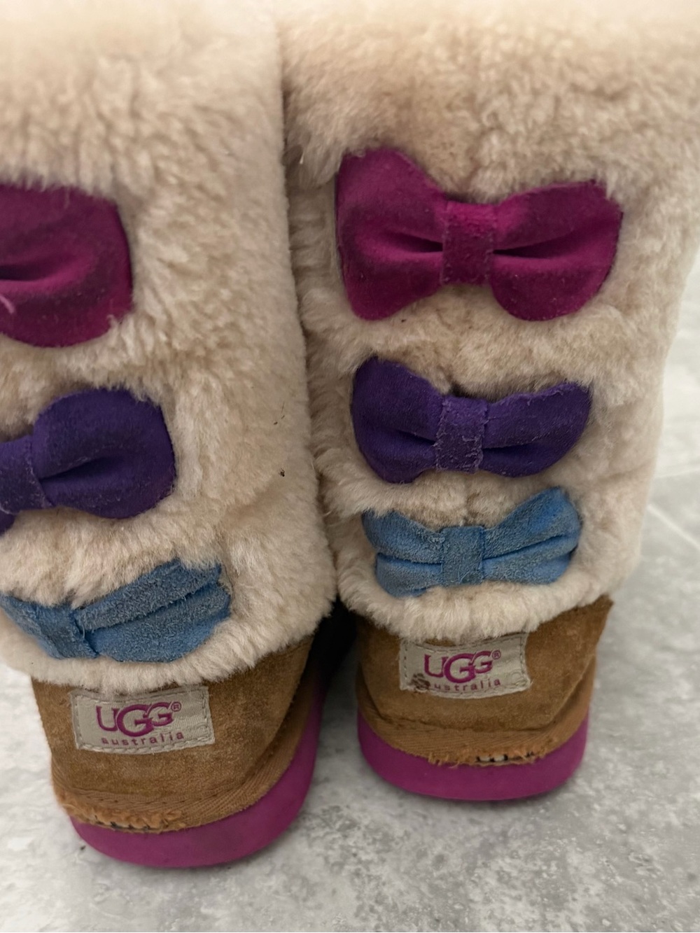 UGG Kids Beige Shearling Boots with Pink, Purple and Blue Bows
